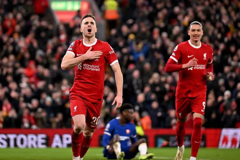 Diogo Jota of Liverpool celebrates after scoring the opening goal during the Premier League match between Liverpool FC and Chelsea FC at Anfield on January 31, 2024 in Liverpool, England.