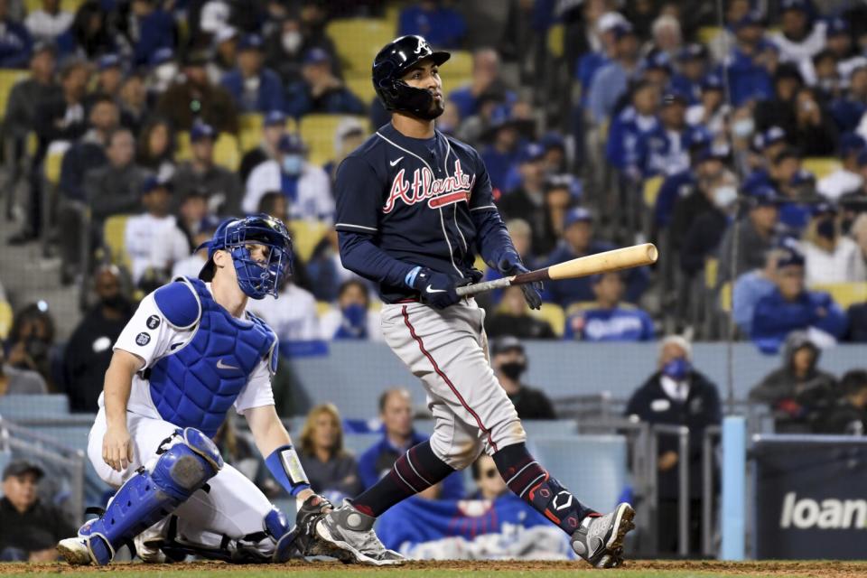 Braves' Eddie Rosario looks up after hitting a three-run home run.