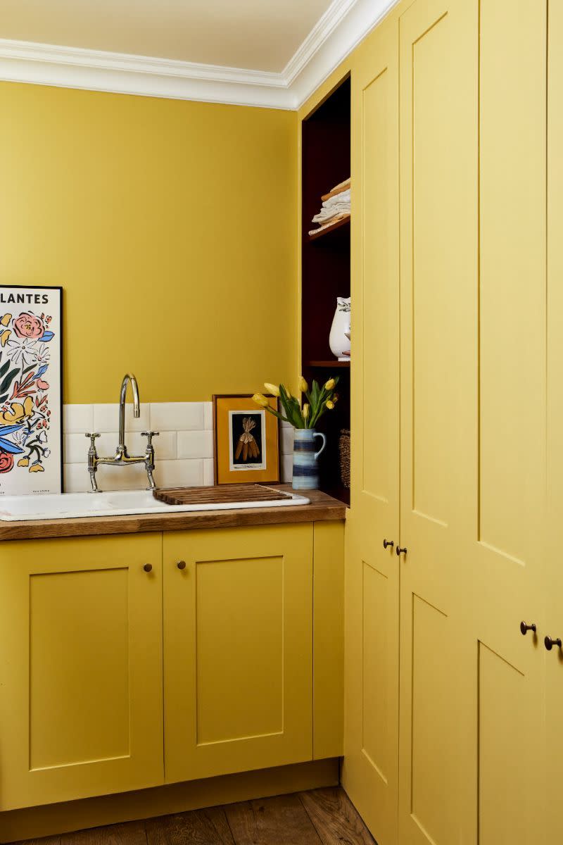 <p>The all-over yellow <a href="https://www.housebeautiful.com/uk/decorate/walls/a39557917/paint-colour-chart/" rel="nofollow noopener" target="_blank" data-ylk="slk:paint;elm:context_link;itc:0;sec:content-canvas" class="link ">paint</a> is a clever design trick here. Creating lots of breaks with different bands or blocks of colour can interrupt the eye and natural line of vision, making a room seem smaller.<br></p><p>Pictured: <a href="https://mylands.com/products/haymarket" rel="nofollow noopener" target="_blank" data-ylk="slk:Cabinetry and walls in Haymarket No.47 at Mylands;elm:context_link;itc:0;sec:content-canvas" class="link ">Cabinetry and walls in Haymarket No.47 at Mylands</a></p>