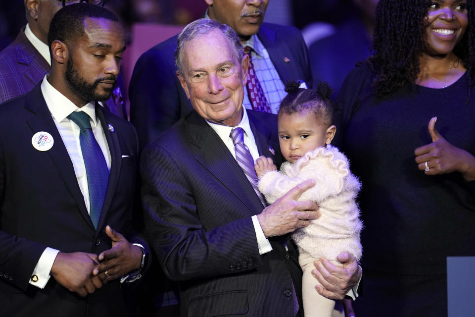 Democratic presidential candidate and former New York City Mayor Michael Bloomberg is joined on stage by supporters during his campaign launch of "Mike for Black America," at the Buffalo Soldiers National Museum, Thursday, Feb. 13, 2020, in Houston. (AP Photo/David J. Phillip)