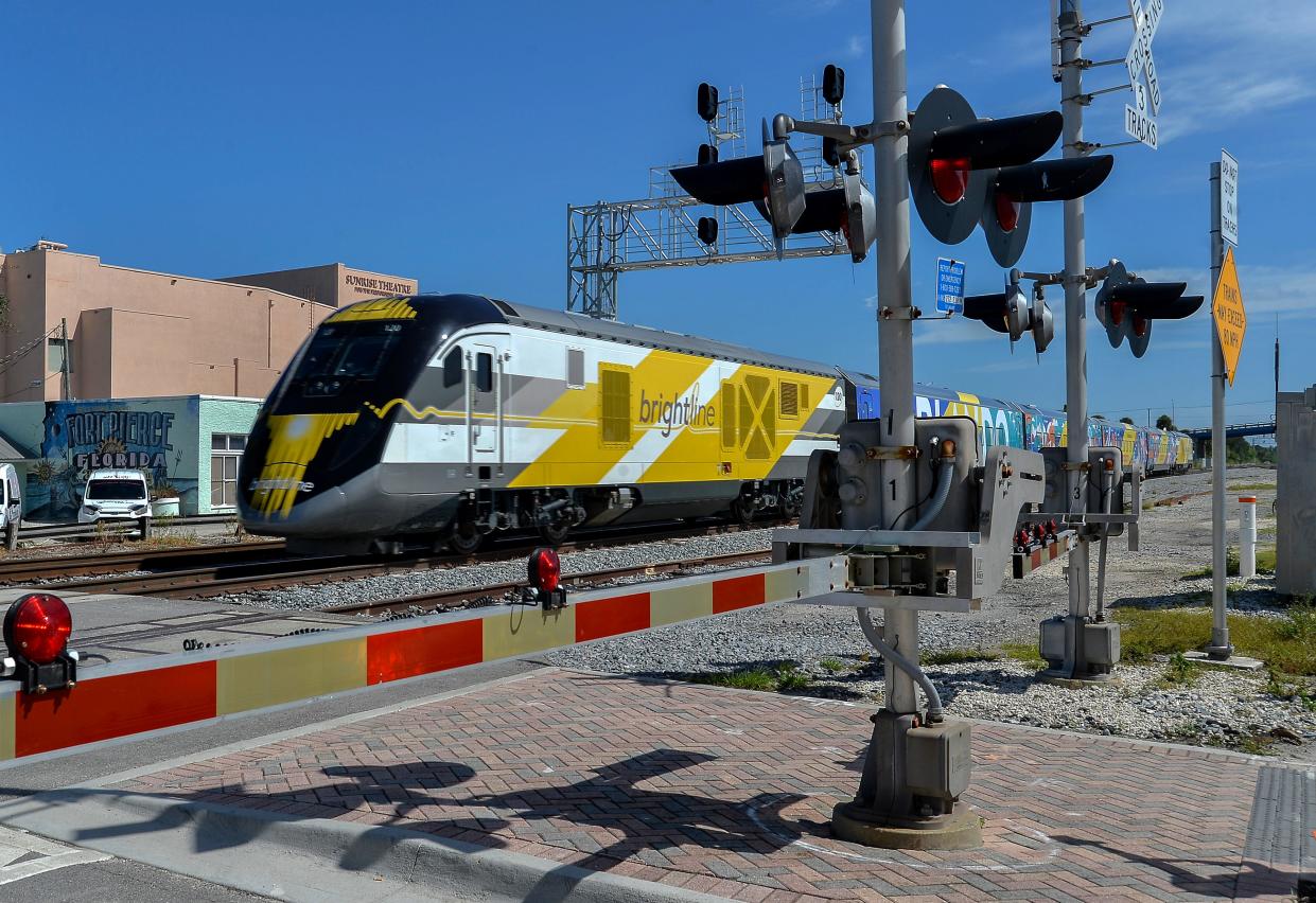 A Brightline train passes by the Sunrise Theatre at the Orange Avenue crossing at 38 mph as it heads north through St. Lucie County on Friday, Sept. 22, 2023, on its way to Orlando on the first day of transporting passengers.