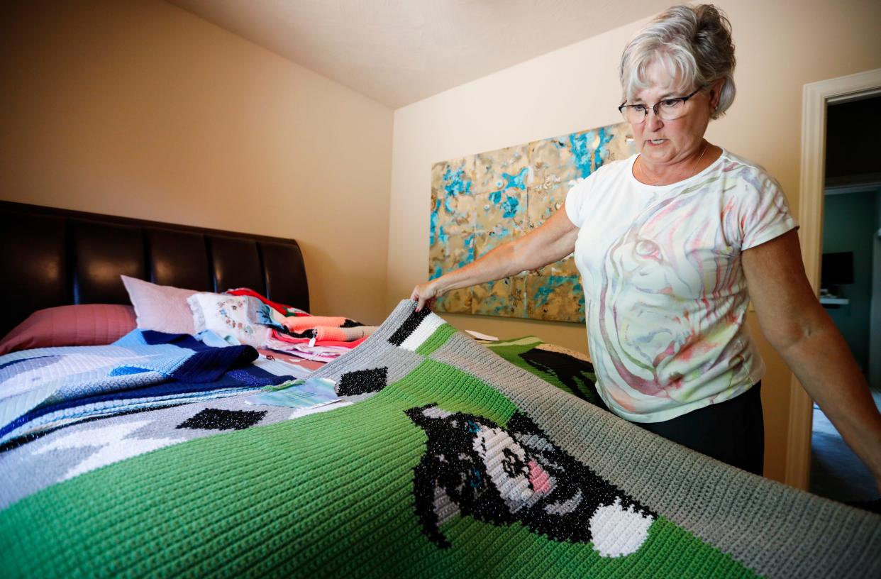 Dottie Lash shows a dog blanket she crocheted on Thursday, June 13, 2024.