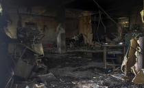 Charred furniture and other items are seen after a deadly fire at the Welfare Hospital in Bharuch, western India, Saturday, May 1, 2021. The fire in a COVID-19 ward of the hospital killed multiple patients early Saturday, as the country grappling with the worst outbreak yet steps up a vaccination drive for all its adults even though some states say don't have enough jabs. (AP Photo/Viral Rana)