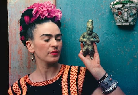 Frida Kahlo with Olmec figurine, 1939, photograph by Nickolas Muray - Credit: Nickolas Muray Photo Archives