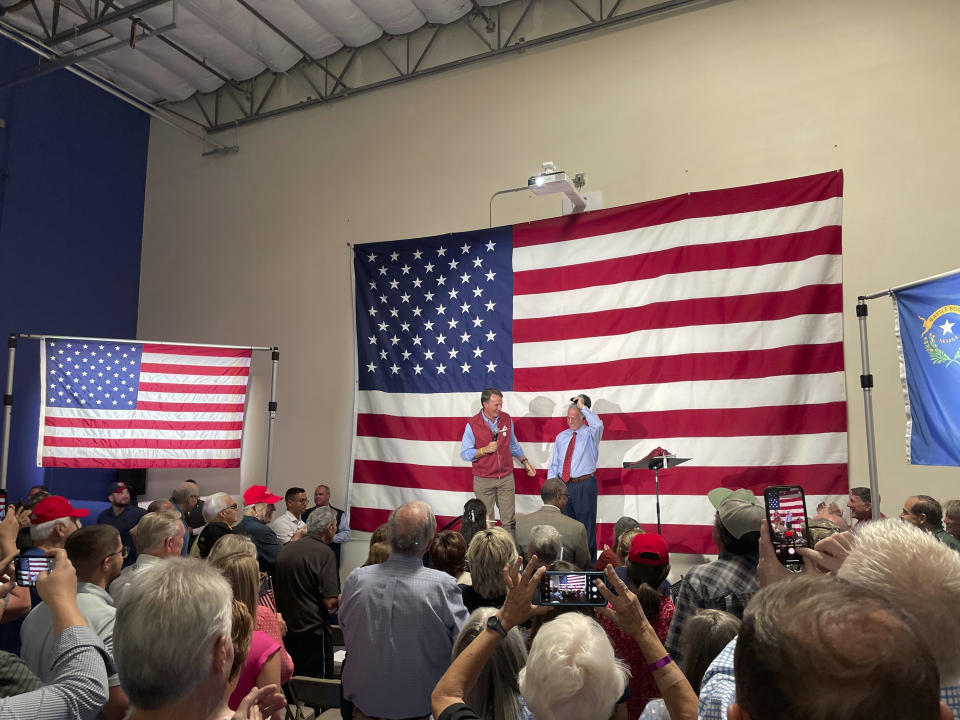 Virginia Gov. Glenn Youngkin, center left, speaks at an event in support of Nevada Republican gubernatorial nominee Joe Lombardo, center right, at the Nevada Trucking Association in Reno, Nev., Thursday, Sept. 15, 2022. (AP Photo/Gabe Stern)