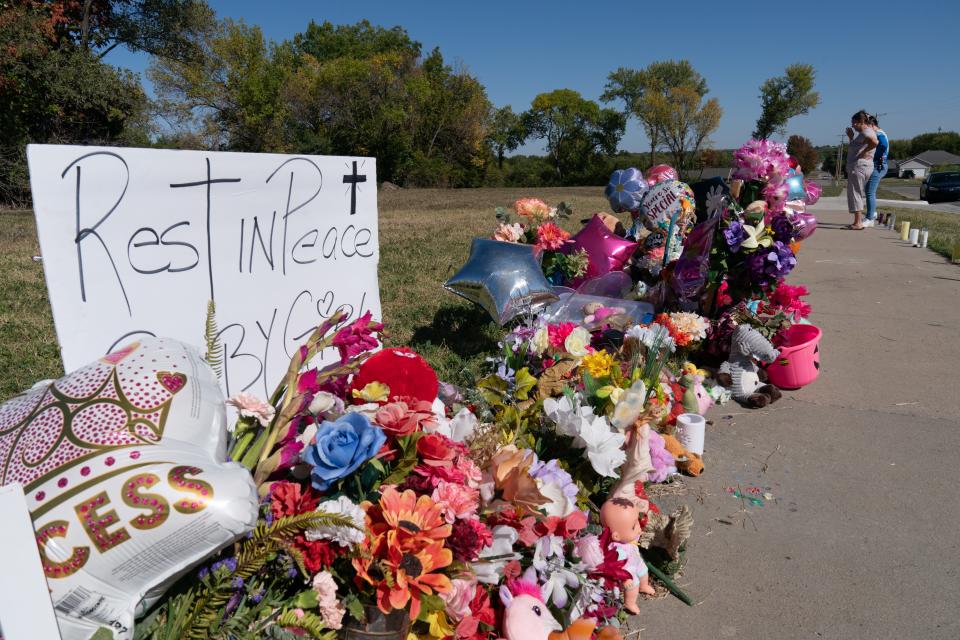 Flowers, signs, children's toys and other items are placed in the area to remember 5-year-old Zoey Felix north of Dillons at 2010 S.E. 29th St.