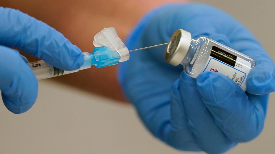 Registered nurse Lindsey Meyer prepares to administer the Moderna COVID-19 vaccine on Tuesday at the Davis County Legacy Center in Farmington, Utah.