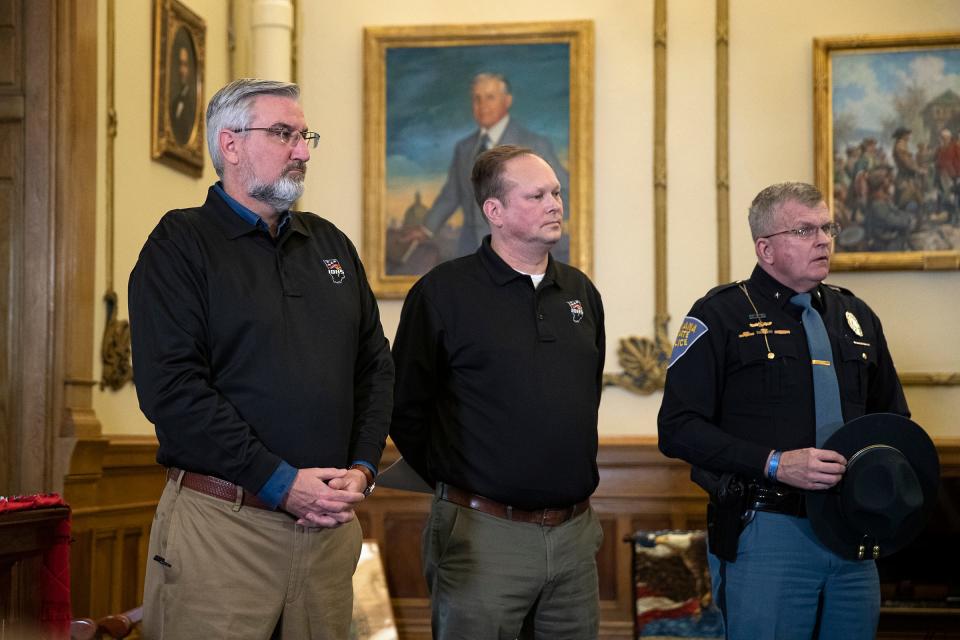 Indiana Governor Eric Holcomb (from left), Department of Homeland Security Executive Director Steve Cox and State Police Superintendent Douglas Carter listen to a press conference about the impending winter storm Wednesday, Feb. 2, 20221, at the Statehouse in Indianapolis.