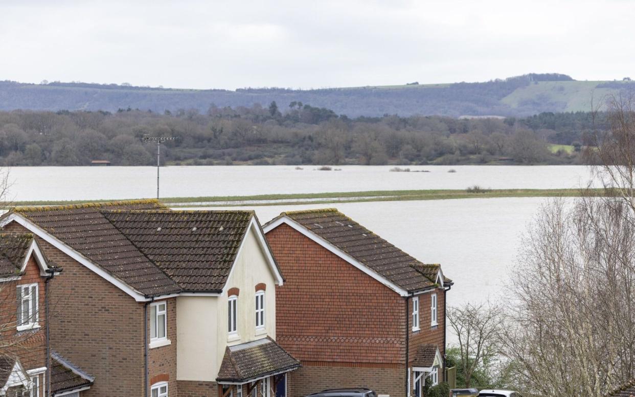 Flood water, from the burst banks of River Arun following heavy rains during storm Henk