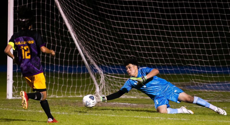 Bell Bulldogs goalkeeper Denis Serrano (1) as a save in the first half. The Oak Hall Eagles and the Bell Bulldogs competed in the District 2-6A boys soccer championship game at Saint Francis Catholic Academy in Gainesville, FL on Thursday, February 2, 2023. Bell defeated Oak Hall 2-1.  [Doug Engle/Ocala Star Banner]