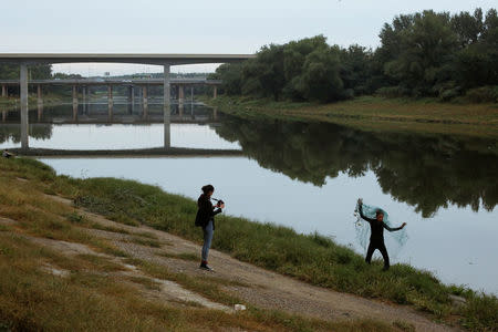 Chinese performance artist Han Bing poses for German photographer Katharina Hesse during a shoot at the outskirts of Beijing, China, October 2, 2017. REUTERS/Thomas Peter