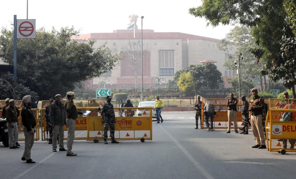 Indian Security personnel and Delhi police members check people and vehicles heading towards the Parliament House in New Delhi, India, 13 December 2023 (EPA)