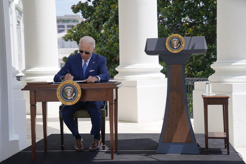President Joe Biden signs two bills aimed at combating fraud in the COVID-19 small business relief programs Friday, Aug. 5, 2022, at the White House in Washington. (AP Photo/Evan Vucci, Pool)
