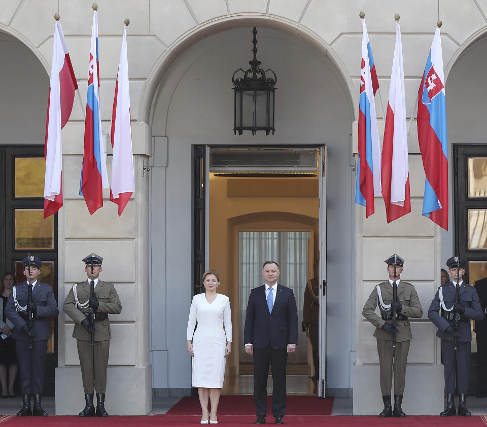 Polish President Andrzej Duda, right, and Slovakian President Zuzana Caputova, left, attend a military welcome ceremony at the presidential Palace in Warsaw, Poland, Monday, July 15, 2019. Caputova is staying for an official visit in Poland. (AP Photo/Czarek Sokolowski)