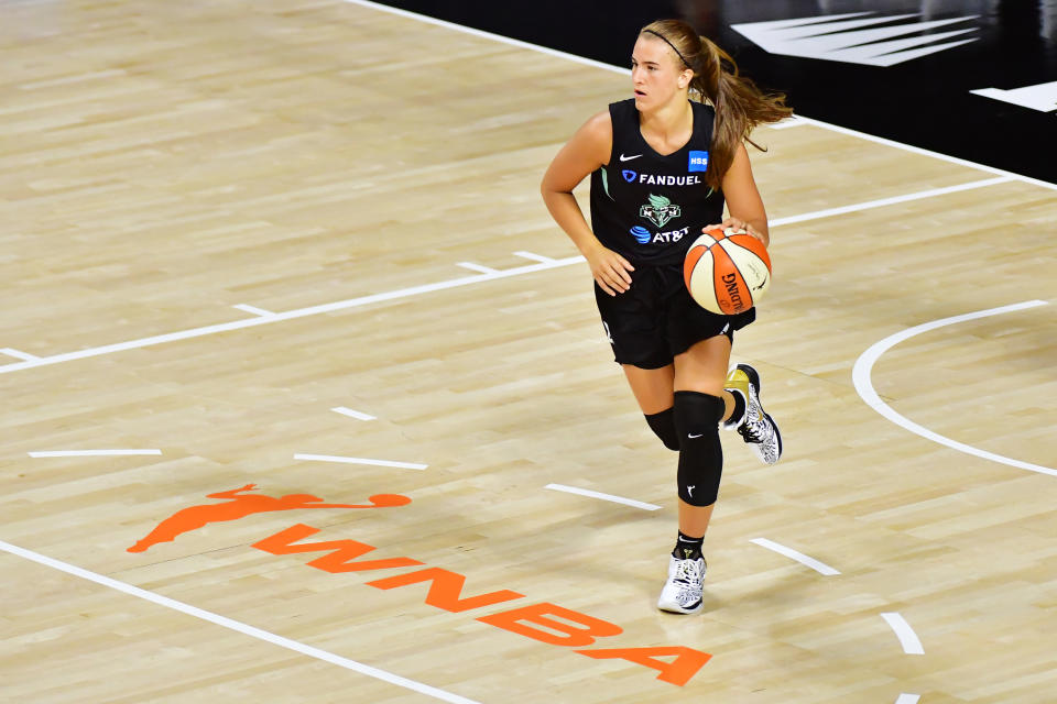 Sabrina Ionescu brings the ball up the court during a WNBA game.