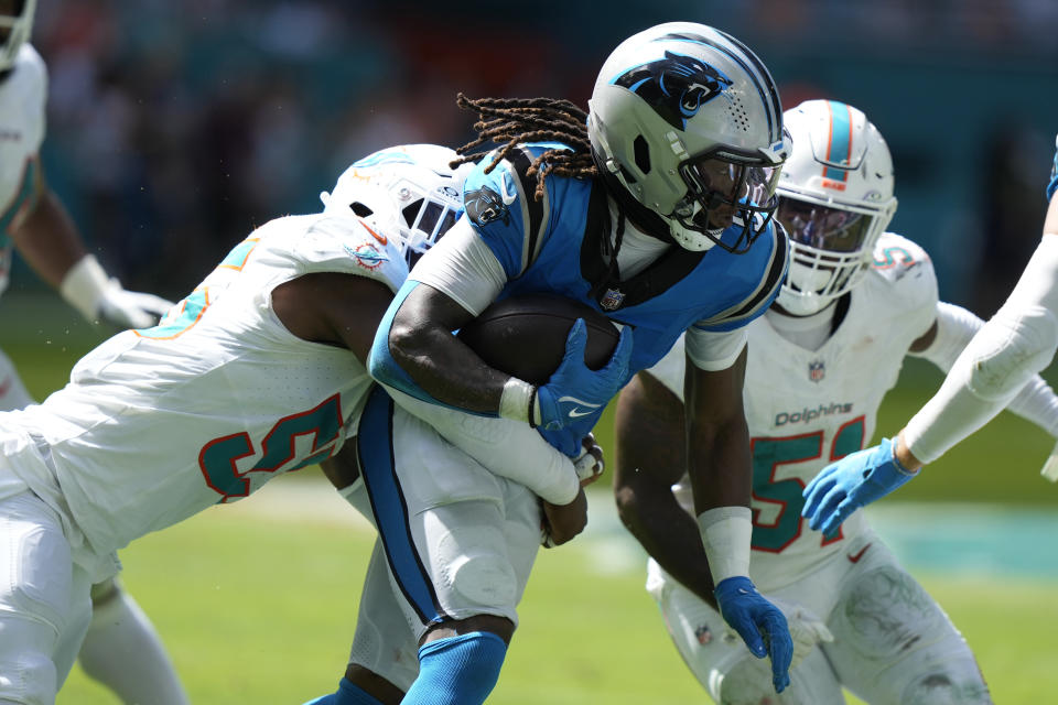 Miami Dolphins linebacker Jerome Baker (55) tackles Carolina Panthers wide receiver Laviska Shenault Jr. (5) during the first half of an NFL football game, Sunday, Oct. 15, 2023, in Miami Gardens, Fla. (AP Photo/Lynne Sladky)