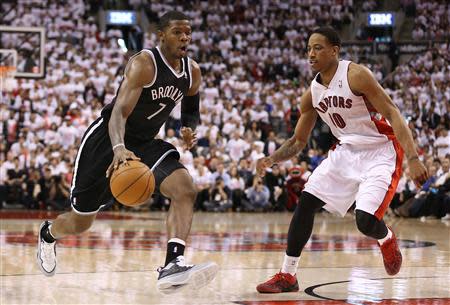 Apr 19, 2014; Toronto, Ontario, CAN; Brooklyn Nets guard Joe Johnson (7) goes to the basket as Toronto Raptors guard DeMar DeRozan (10) plays defense in game one during the first round of the 2014 NBA Playoffs at Air Canada Centre. The Nets beat the Raptors 94-87. Mandatory Credit: Tom Szczerbowski-USA TODAY Sports