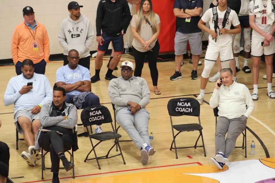 Kentucky men’s basketball head coach John Calipari, far right, talks on the phone while watching an AAU basketball game July 6 at the Nike EYBL Peach Jam tournament in North Augusta, S.C. Calipari was joined at the game by UK assistant coach Chin Coleman, second from right.