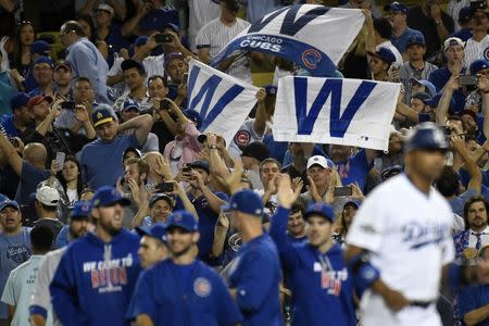 Oct 20, 2016; Los Angeles, CA, USA; Chicago Cubs fans hold up flags after the Chicago Cubs defeat the Los Angeles Dodgers 8-4 in game five of the 2016 NLCS playoff baseball series at Dodger Stadium. Mandatory Credit: Richard Mackson-USA TODAY Sports