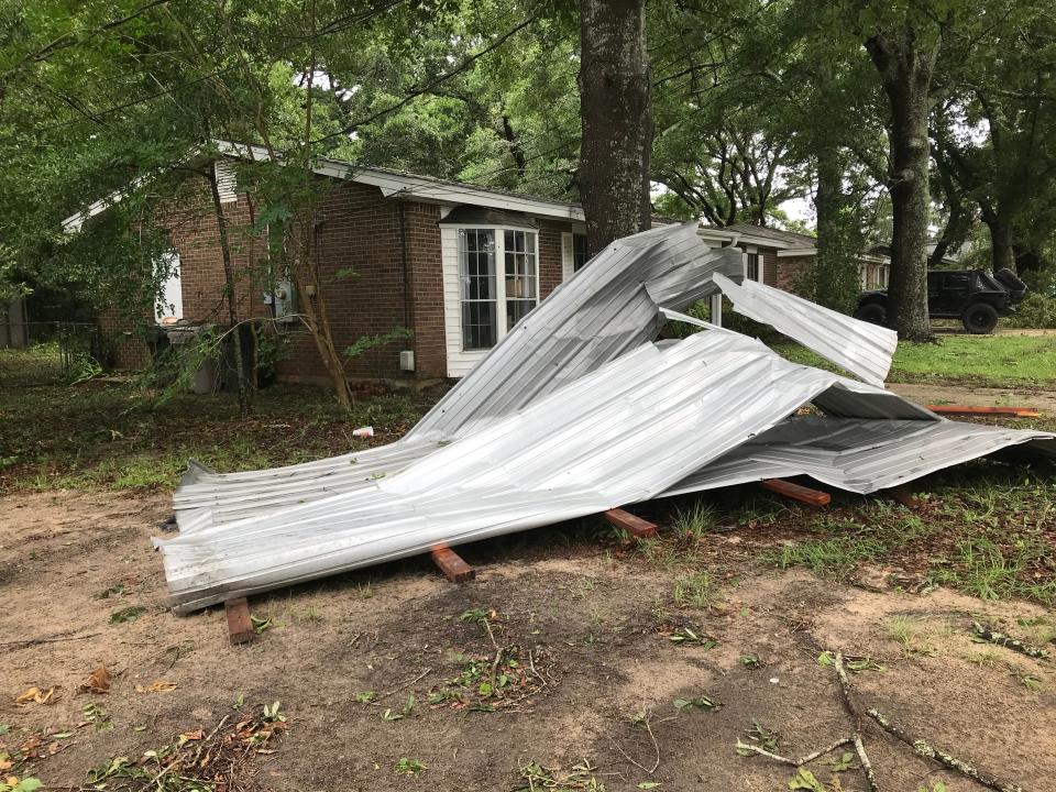 Debris and downed limbs are scattered throughout the Ferry Pass area after severe storms Wednesday.