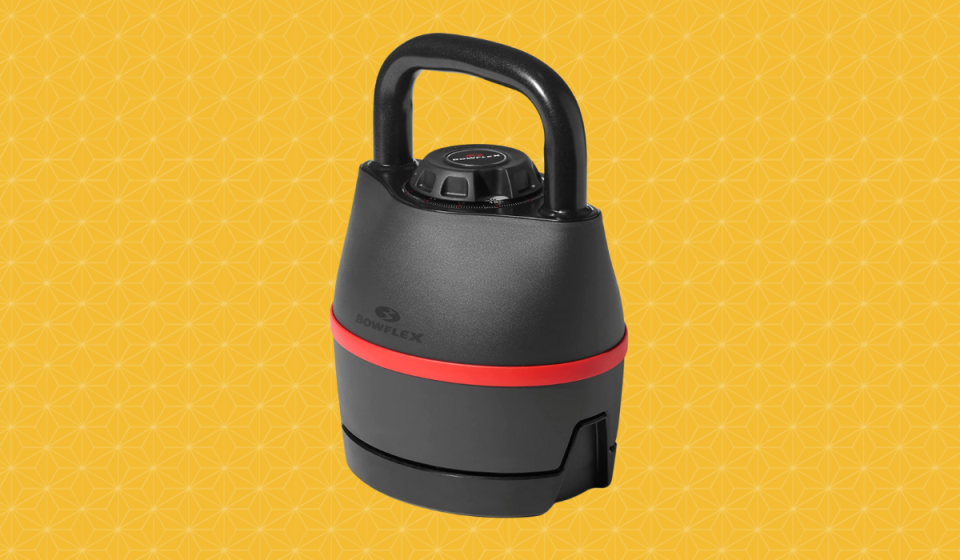 The Bowflex SelectTech 840 Kettlebell, which is black with a red stripe in the middle and a handle on top, is shown against a patterned yellow background.