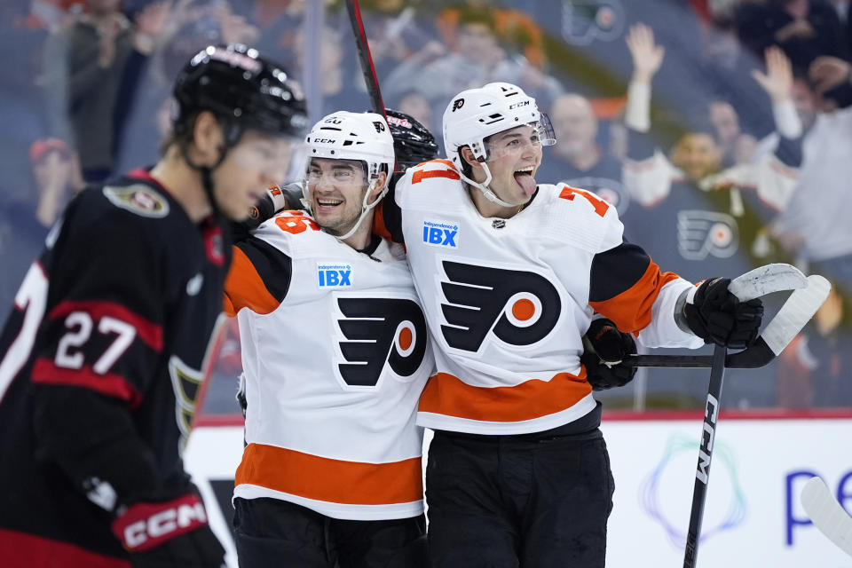 Philadelphia Flyers' Tyson Foerster, right, and Sean Walker, center, celebrate past Ottawa Senators' Parker Kelly after Foerster's goal during the second period of an NHL hockey game, Saturday, March 2, 2024, in Philadelphia. (AP Photo/Matt Slocum)