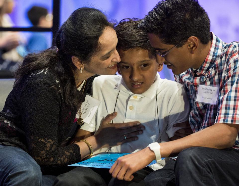 Jairam Hathwar of Corning, New York, is comforted by his parents Roopa (L) and Sriram after he failed to spell "riegel" during the semi-final round of the 88th annual Scripps National Spelling Bee at National Harbor, Maryland May 28, 2015. (REUTERS/Joshua Roberts)