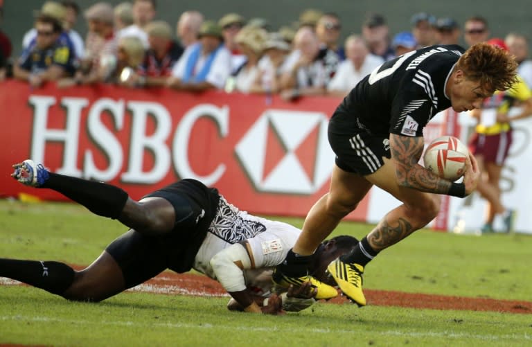 New Zealand's Declan O'Donnell evades a tackle from Fiji's Pio Tuwai during their IRB's 10-leg World Rugby Sevens Series match, in Dubai, in December 2015