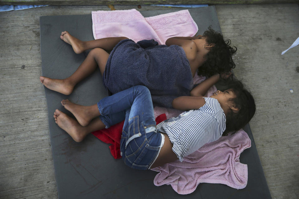 FILE - Migrant children sleep on a mattress on the floor of the AMAR migrant shelter in Nuevo Laredo, Mexico, on July 17, 2019. A federal judge has ordered the U.S. government to allow the return of 11 parents who were deported without their children during the Trump administration's wide-scale separation of immigrant families. (AP Photo/Marco Ugarte, File)