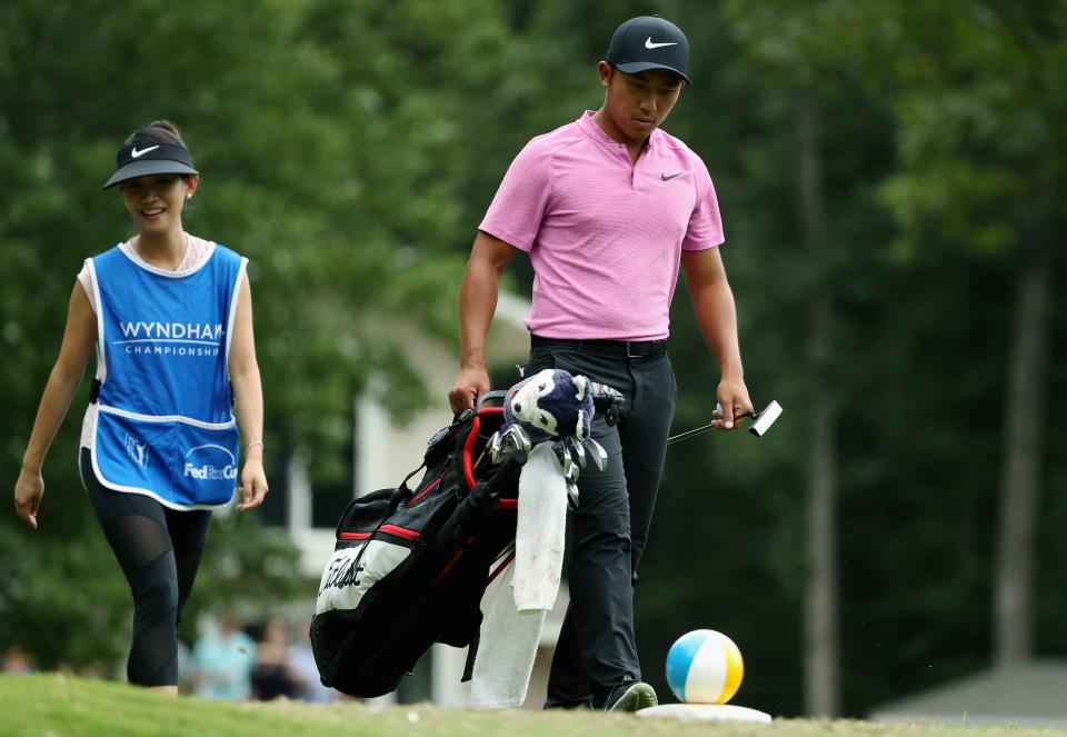 GREENSBORO, NC - AUGUST 18:  C.T. Pan of Taiwan walks the seventh tee with his wife and caddie Michelle Lin during the third round of the Wyndham Championship at Sedgefield Country Club on August 18, 2018 in Greensboro, North Carolina.  (Photo by Streeter Lecka/Getty Images)