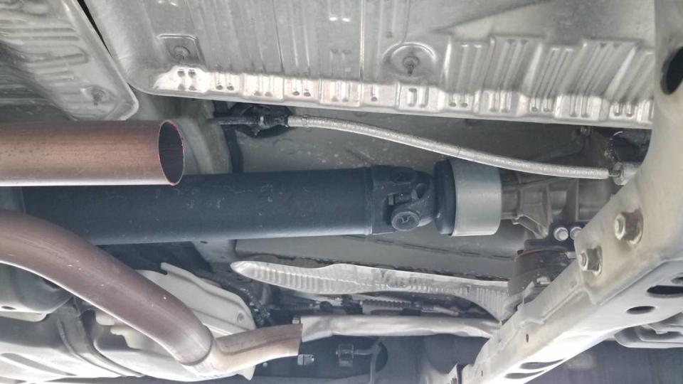 This photo was taken from underneath a Toyota truck on Tuesday, March 14, 2021, after the catalytic converter was stolen. Specks of red paint can be seen left on the remaining pipe.