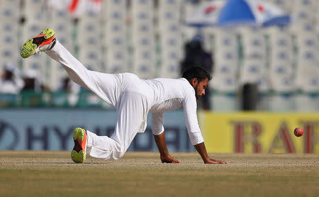 Cricket - India v England - Third Test cricket match - Punjab Cricket Association Stadium, Mohali, India - 28/11/16. England's Adil Rashid dives to stop the ball. REUTERS/Adnan Abidi