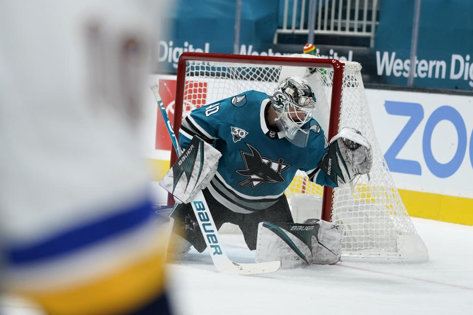 San Jose Sharks goaltender Devan Dubnyk can't stop a goal by St. Louis Blues center Brayden Schenn during the second period of an NHL hockey game in San Jose, Calif., Saturday, Feb, 27, 2021. (AP Photo/Tony Avelar)