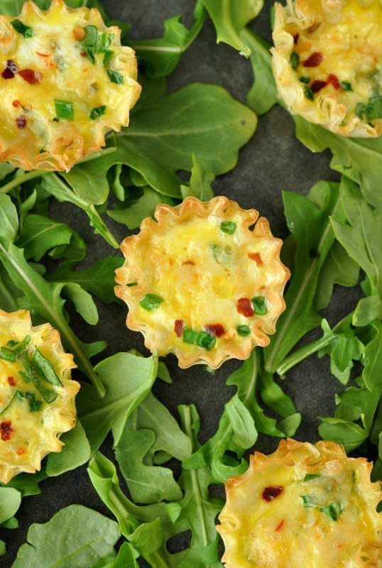 <p>Peas and Crayons</p><p>These adorable mini phyllo quiche cups are one of our favorite things to serve for breakfast and brunch! These tasty breakfast bites are ready to scarf in just 15 minutes!</p><p><strong>Get the recipe: <a href="https://peasandcrayons.com/2014/12/mini-phyllo-quiche-cups.html" rel="nofollow noopener" target="_blank" data-ylk="slk:Mini Phyllo Quiche Cups;elm:context_link;itc:0;sec:content-canvas" class="link rapid-noclick-resp"><em>Mini Phyllo Quiche Cups</em></a></strong></p>