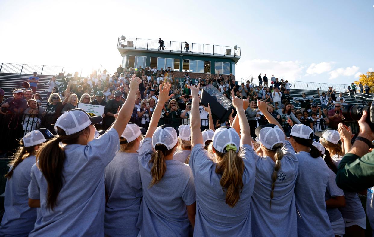 Michigan State players celebrate with fans with their Big Ten championship trophy after defeating Rutgers, Sunday, Oct. 23, 2022, in East Lansing.