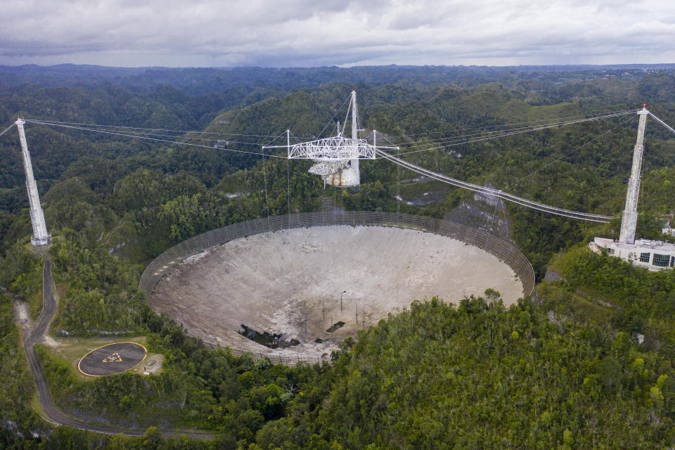 This aerial view shows a hole in the dish panels of the Arecibo Observatory in Puerto Rico, on November 19, 2020. (Photo by Ricardo Arduengo/AFP via Getty Images)