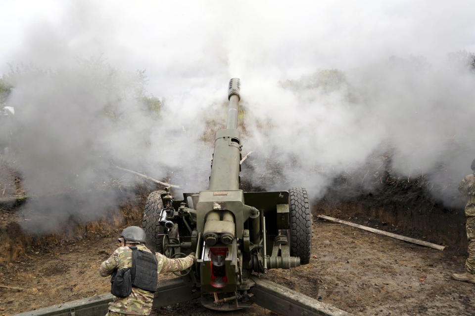 Ukrainian soldiers fire, on the front line in the Kharkiv region, Ukraine, Wednesday, Oct. 5, 2022. (AP Photo/Andrii Marienko)