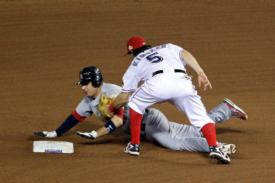 ARLINGTON, TX - OCTOBER 24: Jon Jay #19 of the St. Louis Cardinals is caught stealing at second base by Ian Kinsler #5 of the Texas Rangers in the seventh inning during Game Five of the MLB World Series at Rangers Ballpark in Arlington on October 24, 2011 in Arlington, Texas. (Photo by Ezra Shaw/Getty Images)