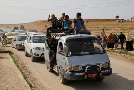 Iraqi families and youths enjoy their Friday holiday at Shallalat district (Arabic for "waterfalls") in eastern Mosul, Iraq, April 21, 2017. REUTERS/ Muhammad Hamed