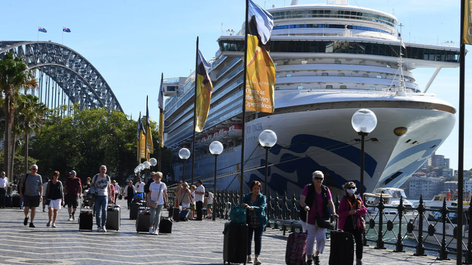 Passengers are seen disembarking the Ruby Princess cruise in Sydney on Thursday. 