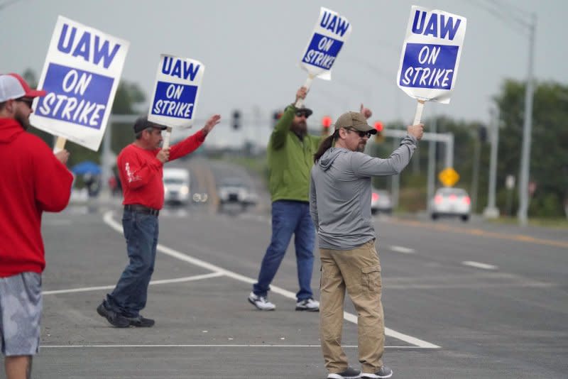 Striking United Auto Workers hold their signs as passing cars honk in front of the General Motors Wentzville Assembly Plant in Wentzville, Missouri on Saturday. Photo by Bill Greenblatt/UPI