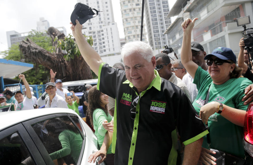 Panama's President Ricardo Martinelli waves to people after casting his vote at a polling station during general election in Panama City, Sunday, May 4, 2014. Panamanians are choosing Martinelli's successor in a three-way dogfight marked more by ugly personality clashes than any deep disagreements over the way forward for Latin America's standout economy. (AP Photo/Tito Herrera)