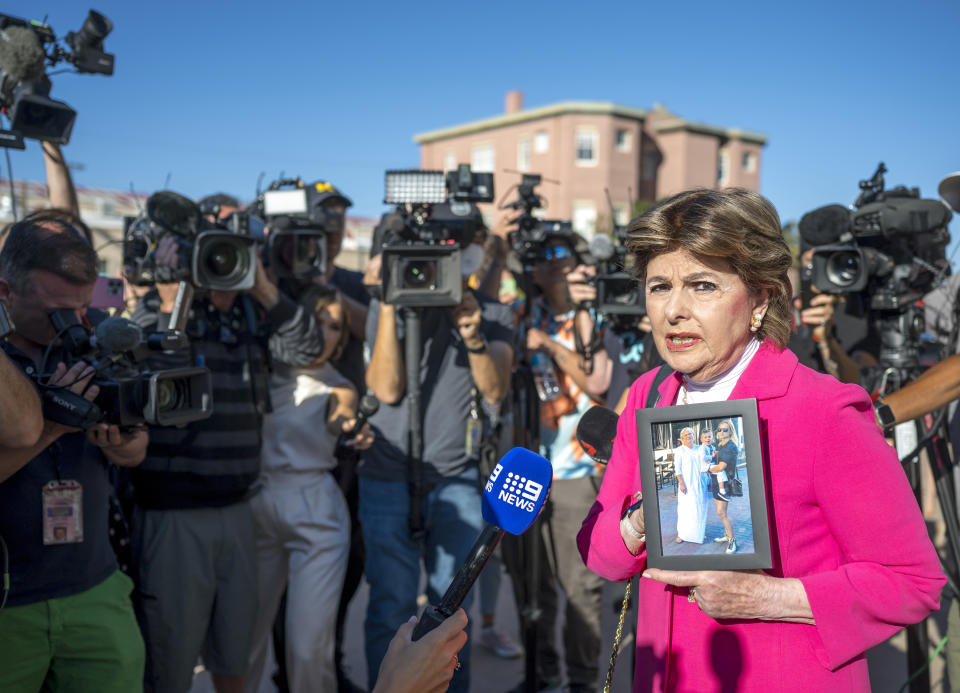 Attorney Gloria Allred holds a picture of Halyna Hutchins outside a District Court in which Alec Baldwin is facing involuntary manslaughter charge for her fatal shooting on the set of 'Rust', in Santa Fe, N.M., Wednesday, July 10, 2024. (AP Photo/Roberto E. Rosales)