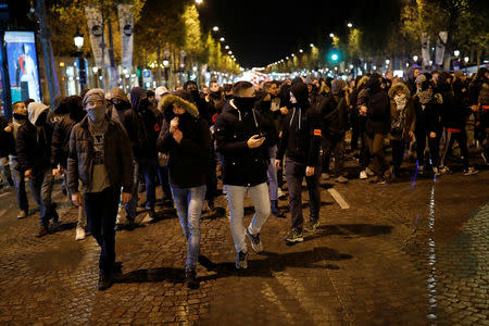 French plainclothes policemen gather during an unauthorised protest against anti-police violence on the Champs Elysees in Paris, France, early October 20, 2016. REUTERS/Benoit Tessier