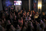 People react as they stand and sit in the main bar of the Royal Hotel watching on television screens the marriage ceremony of Britain's Prince Harry and fiancee Meghan Markle in Sydney, Australia, May 19, 2018. REUTERS/David Gray