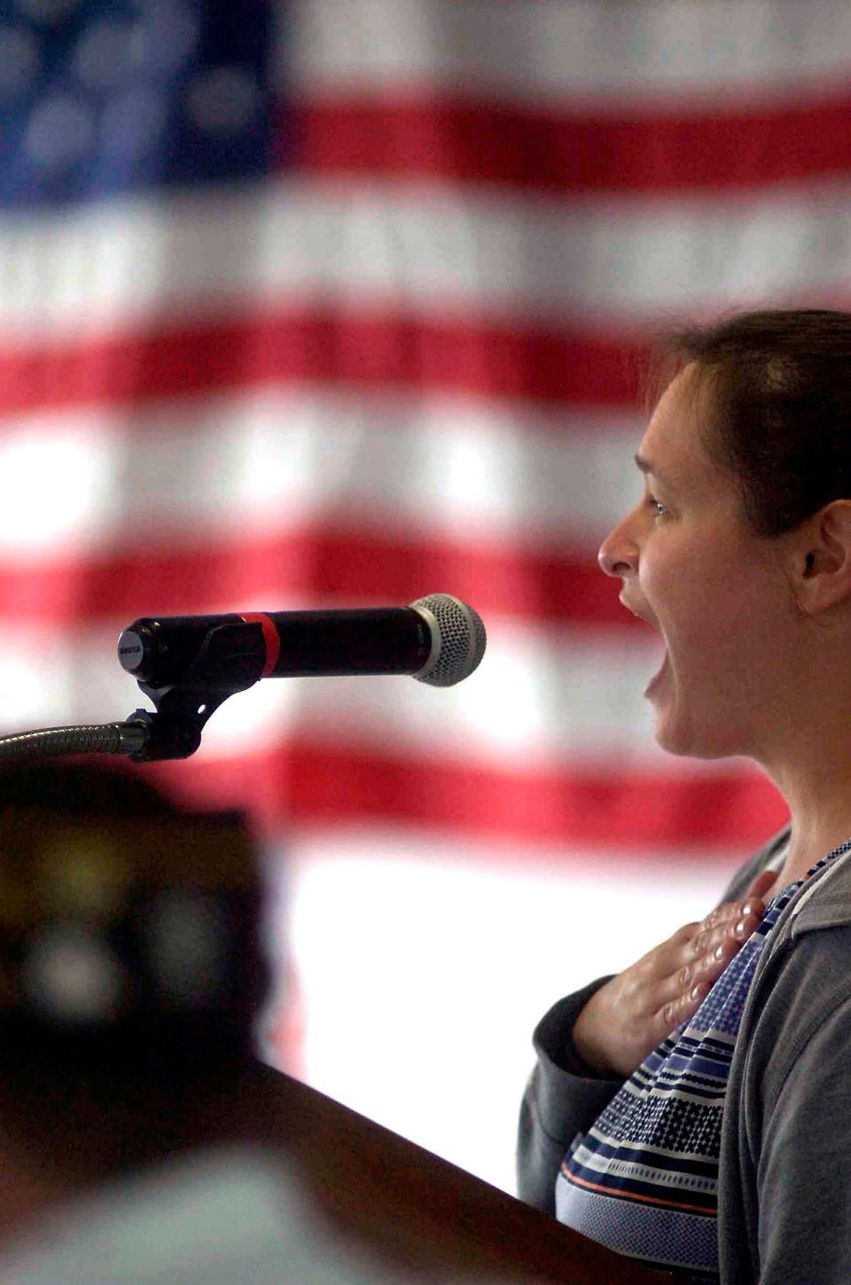 Danielle England sings the national anthem during Monday's Ashland County Fair tribute to veterans.