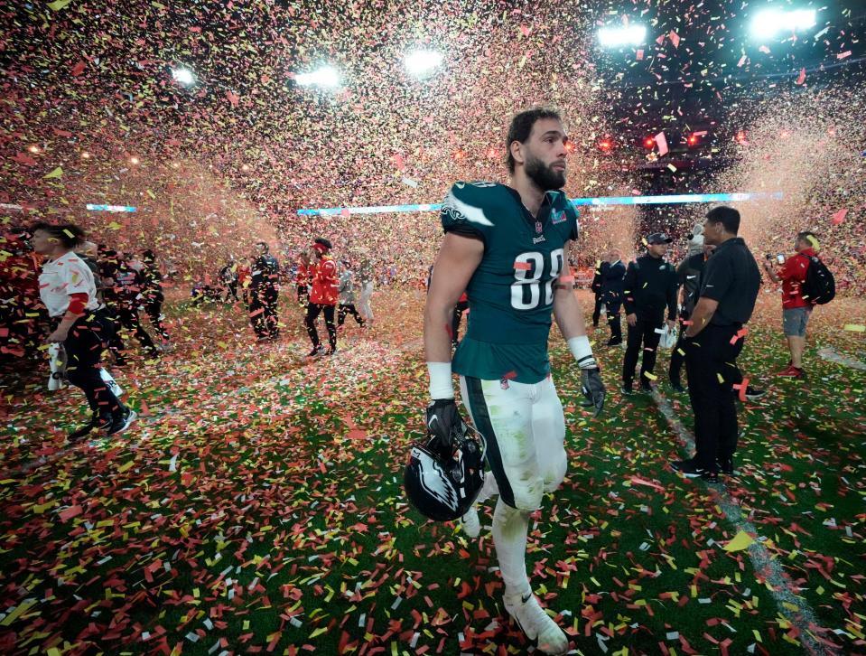 Philadelphia Eagles tight end Dallas Goedert walks off the field as confetti falls after losing to the Kansas City Chiefs in Super Bowl LVII at State Farm Stadium.