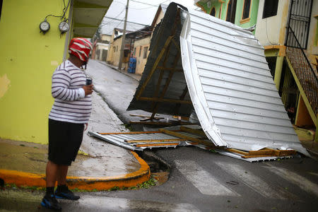 A local stands next to a fallen roof as Hurricane Irma moves off the northern coast of the Dominican Republic, in Puerto Plata, Dominican Republic September 7, 2017. REUTERS/Ivan Alvarado