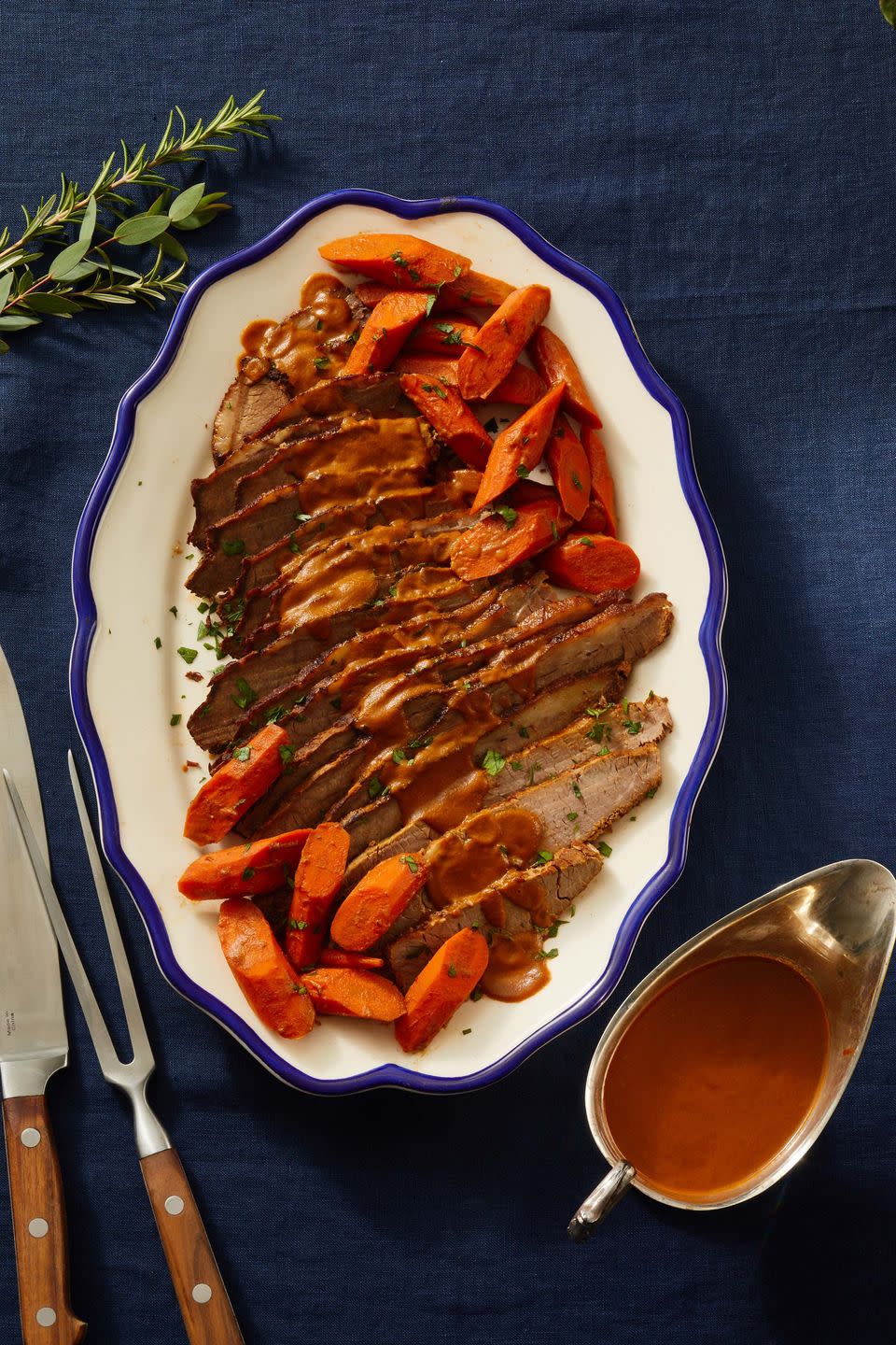 sliced brisket on a plate with carrots