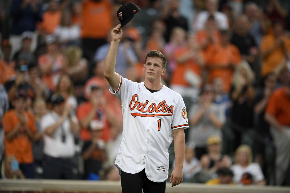 Baltimore Orioles first-round draft pick Adley Rutschman tips his cap to the crowd as he's introduced between innings of a baseball game against the San Diego Padres, Tuesday, June 25, 2019, in Baltimore. (AP Photo/Nick Wass)